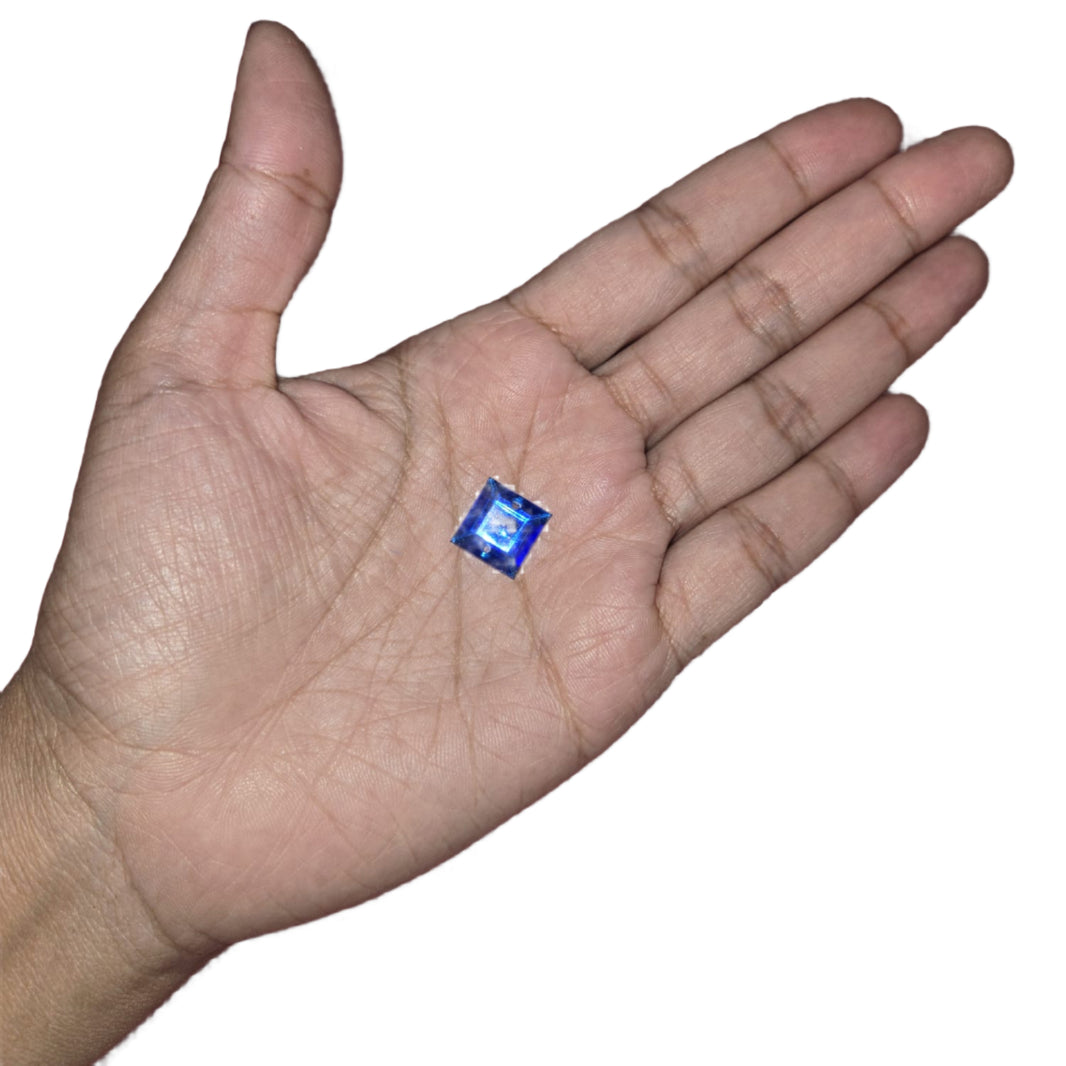 Close-up of a 12mm blue square sew-on rhinestone, perfect for adding sparkle to carnival costumes and custom designs