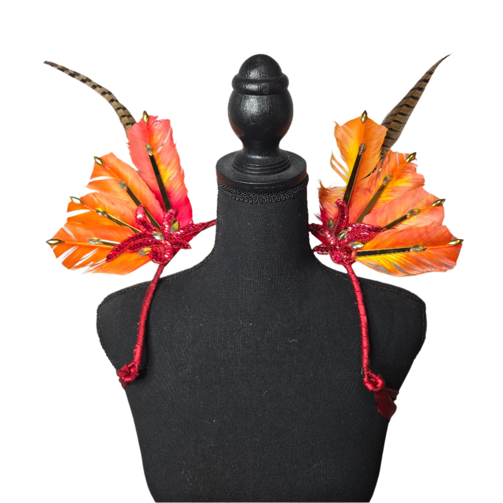 Fiery Sunset Feather Small Collar Wings featuring vibrant orange feathers, shimmering gold accents, and bold red details. Perfectly handcrafted, this lightweight and radiant accessory is designed to sit gracefully around the neck and shoulders, ideal for carnivals, festivals, and performances. #carnivalmw
