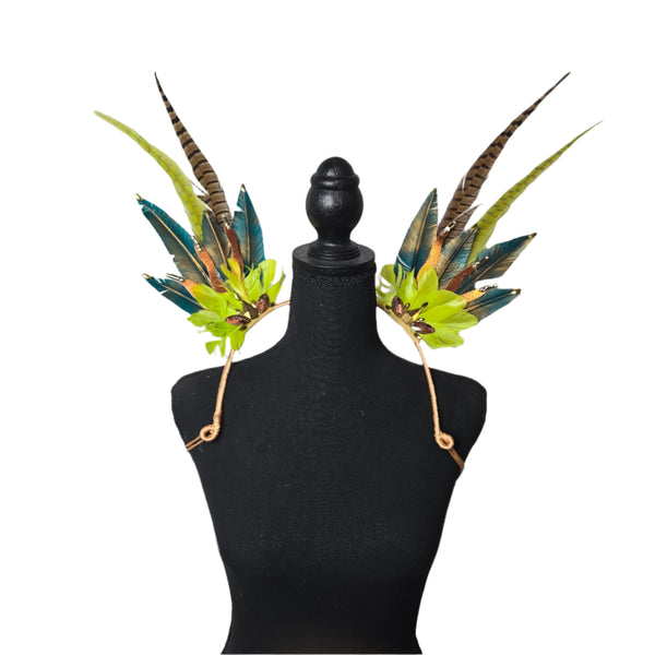 Jungle Luxe Feather Shoulder Wings featuring vibrant green, gold, and earthy-toned feathers, designed for carnivals, festivals, and performances. Lightweight and luxurious, perfect for show-stopping events. #carnivalmw