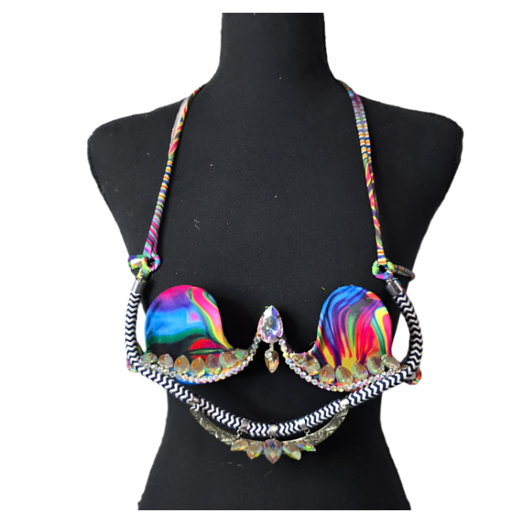 Psychedelic Prism Dream Decorated Wire Bra with swirling multicolor rainbow cups, black and white zigzag trim, and sparkling iridescent gems, displayed on a black mannequin—ideal for festivals, carnivals, and performance wear