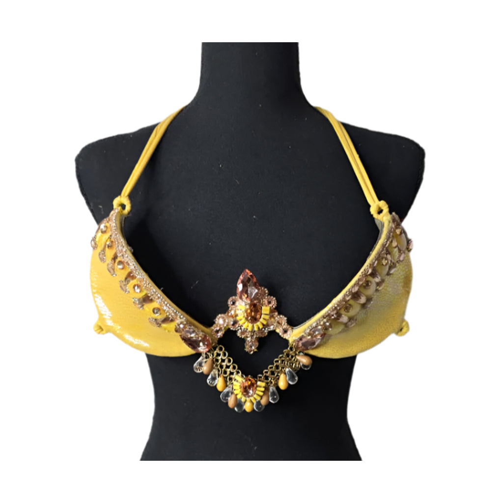 Sun Goddess Decorated Wire Bra featuring a vibrant yellow wire base, radiant gold and amber gem embellishments, and intricate chain accents, displayed on a black mannequin—perfect for carnivals, samba dancers, and festival performances