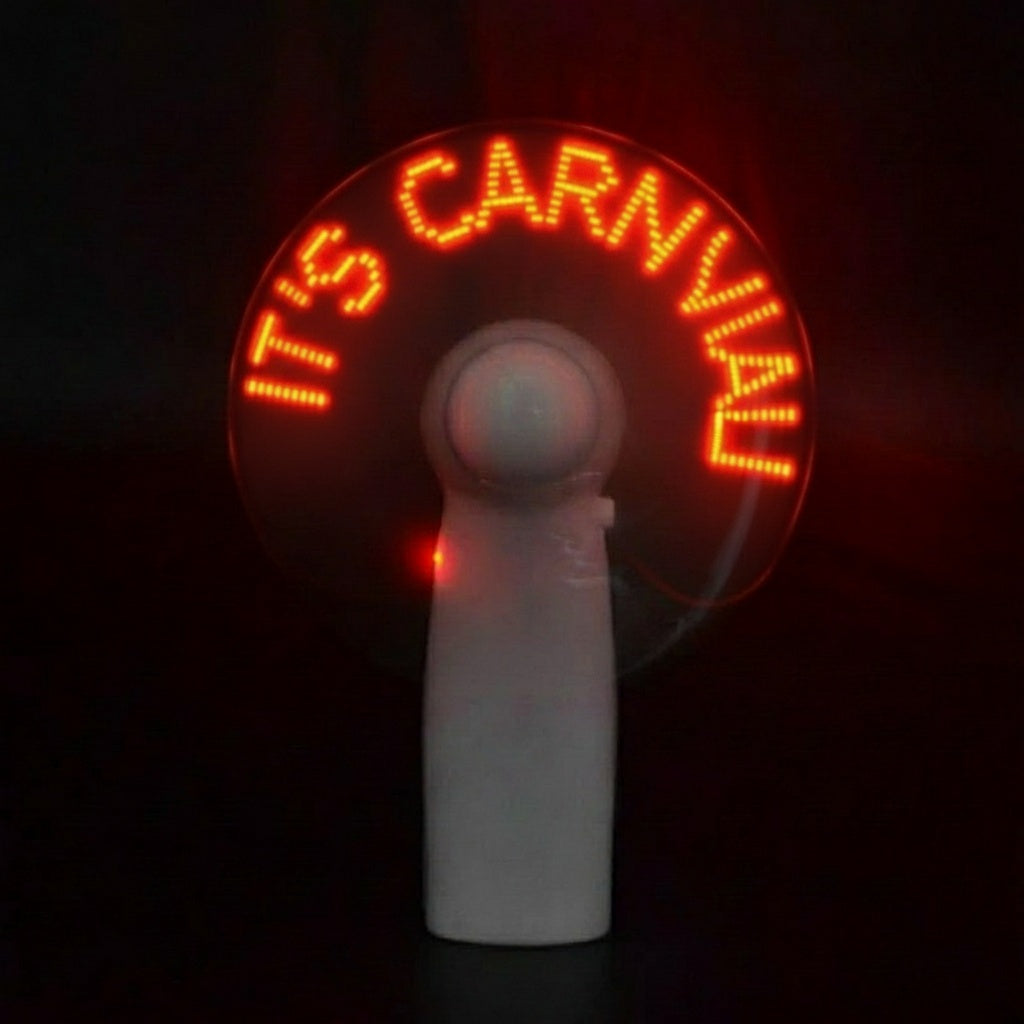 Handheld fan with red LED text on a dark background that says "Its Carnival"