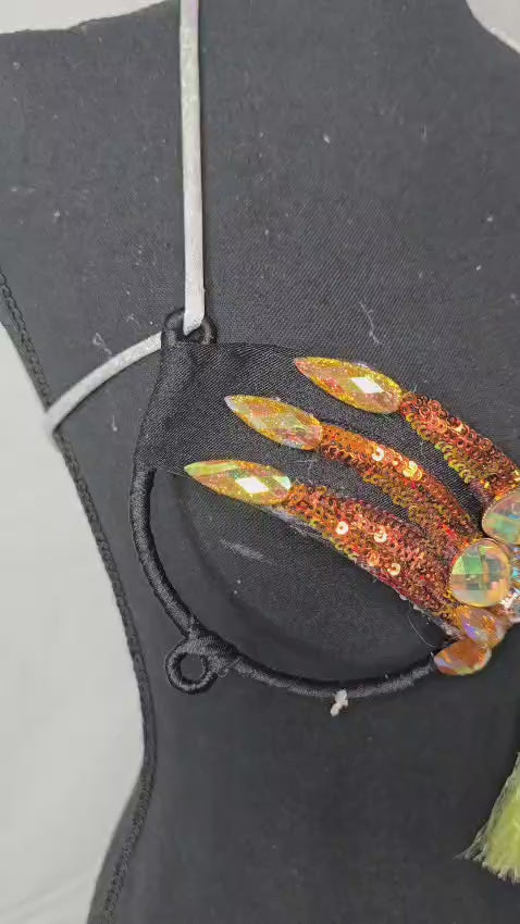 Solar Flare Dream Decorated Wire Bra featuring gold and orange sequin details, iridescent gemstone embellishments, and a central yellow tassel, displayed on a black mannequin—ideal for festivals, carnivals, and show-stopping performances. #CarnivalMW #FestivalFashion #CarnivalReady #WireBra