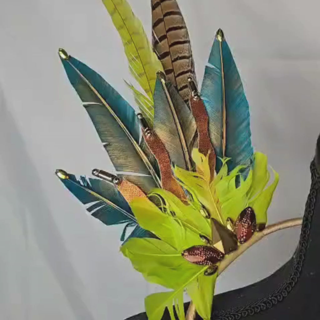 Video of Jungle Luxe Feather Shoulder Wings featuring vibrant green, gold, and earthy-toned feathers, designed for carnivals, festivals, and performances. Lightweight and luxurious, perfect for show-stopping events. #carnivalmw