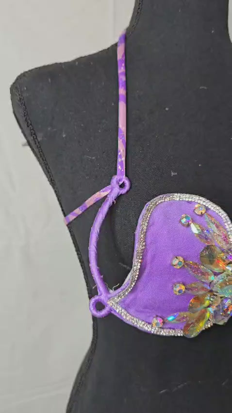 Mystic Orchid Dream Decorated Wire Bra with vibrant purple fabric, iridescent crystal petal embellishments, sparkling beadwork, and dangling center gems, displayed on a black mannequin—ideal for festivals, carnivals, and show-stopping performances. #CarnivalMW #FestivalFashion #CarnivalReady #WireBra