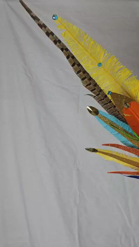 Fiesta Burst Medium Feather Backpack featuring a vibrant mix of yellow, orange, blue, green, and purple feathers with dramatic long plumes; lightweight, adjustable, and handmade for carnival and festival wear. #CARNIVALFEATHERS #CARNIVAL #CARNIVALCOSTUMES