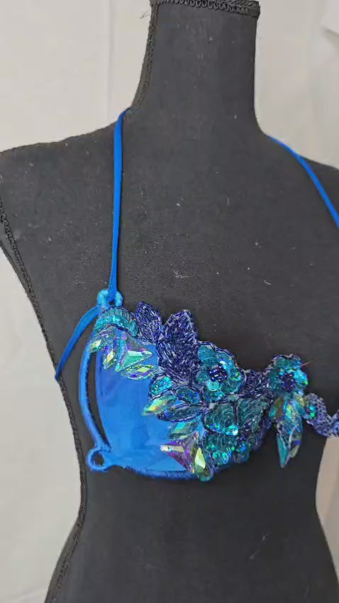 Blue Lagoon Fantasy Decorated Wire Bra with vivid electric blue fabric, covered in sparkling 3D blue gems and floral crystal appliqués, displayed on a black mannequin—perfect for festivals, carnivals, and dazzling performances. #CarnivalMW #FestivalFashion #CarnivalReady #WireBra
