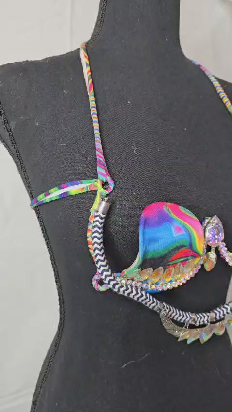 Psychedelic Prism Dream Decorated Wire Bra with swirling multicolor rainbow cups, black and white zigzag trim, and sparkling iridescent gems, displayed on a black mannequin—ideal for festivals, carnivals, and performance wear. #CarnivalMW #CarnivalReady #WireBra